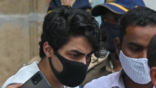 File photo of Aryan Khan, son of Bollywood actor Shah Rukh Khan, being escorted to court by NCB officials for a bail plea hearing. (AFP)(HT_PRINT) File photo of Aryan Khan, son of Bollywood actor Shah Rukh Khan, being escorted to court by NCB officials for a bail plea hearing. (AFP)(HT_PRINT)