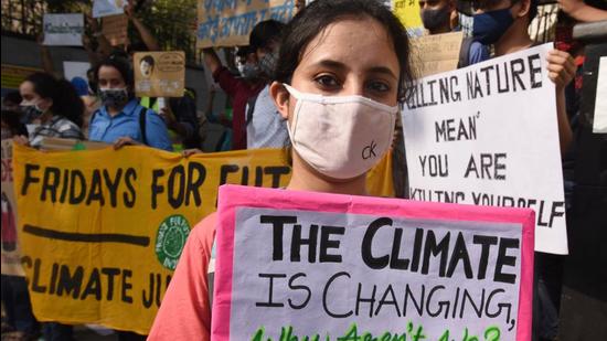 A file photo of a person holding a placard on climate change awareness in New Delhi, India. The WMO released a report on Tuesday that highlights the impact of disasters linked to climate change in India. The development came just days before a UN-led summit on the climate crisis, COP26, starts in Glasgow. (Raj K Raj/HT FILE PHOTO)