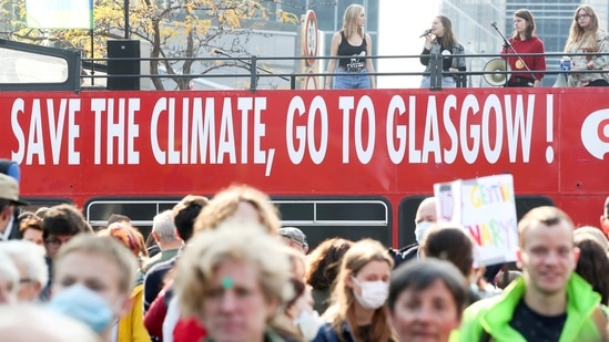 FILE PHOTO: People take part in a Climate March in Brussels, Belgium, ahead of the COP26 climate summit in Glasgow, October 10, 2021. REUTERS/Yves Herman/File Photo(REUTERS)