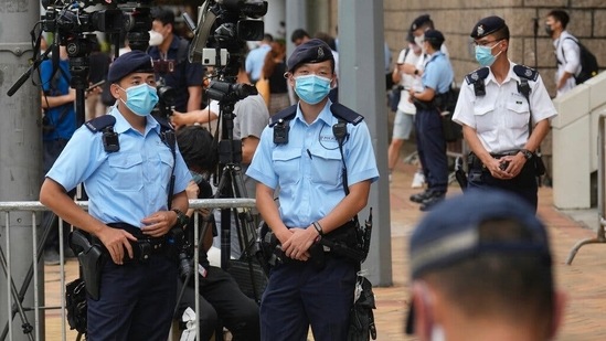 Police officers standing guard outside a court in Hong Kong in July, after the first sentencing under the National Security Law.&nbsp;(Associated Press)
