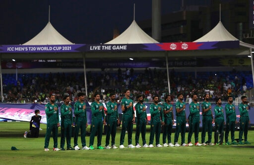 Pakistan players stand for their national anthem before the start of the Cricket Twenty20 World Cup match between New Zealand and Pakistan in Sharjah, UAE, Tuesday, Oct. 26, 2021. (AP Photo/Aijaz Rahi)