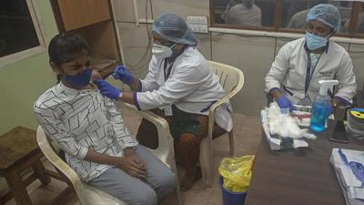 A student gets Covid vaccination jab during a drive held at the college campus in Pune. Special college vaccination drive gets slow response in the city. (HT)