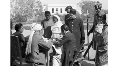 A polling officer is seen issuing an identity slip to a voter outside the Town Hall polling booth in New Delhi in January 1952. (Courtesy Photo Division, PIB)