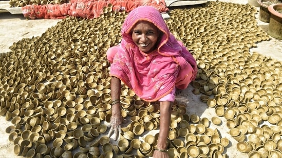 The festival of lights is just around the corner and potters in different parts of India are gearing up to increase the production of earthen lamps. A Muslim family in Chinhat area in Gomti Nagar, Lucknow is working hard to make as many diyas as possible ahead of Diwali and sell in the market.(HT Photo/Deepak Gupta)