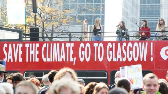 People take part in a climate change awareness march in Brussels, Belgium, ahead of the COP26 climate summit in Glasgow. COP26 president Alok Sharma wants India to pitch a 450GW renewable energy target at the talks (REUTERS/File)
