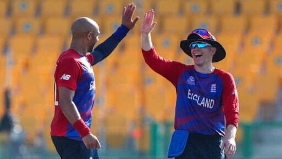 Emirates T20 World Cup Cricket 69 1635342577123 1635342592598 England's captain Eoin Morgan, right, congratulates bowler Tymal Mills after taking the wicket of Bangladesh's Mahedi Hasan during the Cricket Twenty20 World Cup match between England and Bangladesh in Abu Dhabi, UAE, Wednesday, Oct. 27, 2021. (AP Photo/Aijaz Rahi)(AP)