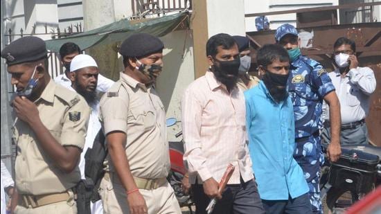 Two of the nine accused taken by the police, at Civil Court in Patna on Wednesday. (Santosh Kumar/HT Photo)