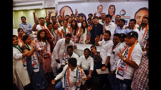 The corporators, who joined NCP from BJP (Ulhasnagar) with the Housing Minister, Jitendra Awhad, in Thane on Wednesday. (PRAFUL GANGURDE/HT PHOTO)