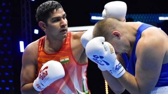 India boxer Narender punches his opponent