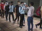 A healthcare worker checks temperatures of passengers arriving from outstation trains in Mumbai (Pratik Chorge/Hindustan Times) A healthcare worker checks temperatures of passengers arriving from outstation trains in Mumbai (Pratik Chorge/Hindustan Times)