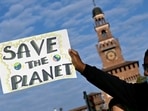 A protester holds up a sign during a climate strike in Milan.