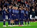 Manchester City players stand on the pitch during the penalty shootout at the end of the English League Cup fourth round soccer match between West Ham United and Manchester City, at the London Stadium, in London, Wednesday, Oct. 27, 2021. Manchester City players stand on the pitch during the penalty shootout at the end of the English League Cup fourth round soccer match between West Ham United and Manchester City, at the London Stadium, in London, Wednesday, Oct. 27, 2021.