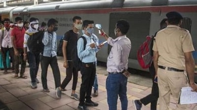 A healthcare worker checks temperatures of passengers arriving from outstation trains in Mumbai (Pratik Chorge/Hindustan Times) A healthcare worker checks temperatures of passengers arriving from outstation trains in Mumbai (Pratik Chorge/Hindustan Times)