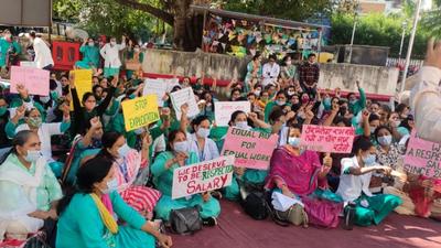 National Health Mission workers protesting at Government Multi-Specialty Hospital (GMSH), Sector 16, Chandigarh on Thursday. (HT PHOTO)