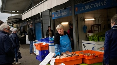 People buy fish at the market of the port of Boulogne-sur-Mer, northern France, Friday, Oct. 15, 2021. (AP Photo) People buy fish at the market of the port of Boulogne-sur-Mer, northern France, Friday, Oct. 15, 2021. (AP Photo)