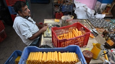 A visually impaired man makes candles to be sold ahead of celebrations for the Hindu festival Diwali or the festival of light at a workshop at the Blind Relief Association in New Delhi. (AFP) A visually impaired man makes candles to be sold ahead of celebrations for the Hindu festival Diwali or the festival of light at a workshop at the Blind Relief Association in New Delhi. (AFP)