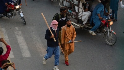 Supporters of the banned Islamist political party Tehreek-e-Labbaik Pakistan (TLP) walk with others as they prepare to march on towards capital Islamabad, during a protest, demanding the release of their leader and the expulsion of the French ambassador over cartoons depicting the Prophet Mohammed, in Gujranwala, Pakistan.&nbsp; (REUTERS)