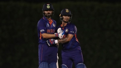 India's captain Virat Kohli, left, congratulates teammate Ishan Kishan on scoring fifty runs (AP)
