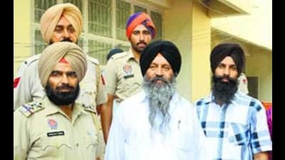 Convicted SGPC member and former militant Kulbir Singh Barapind (centre) in police custody in Jalandhar on Wednesday. (HT Photo)