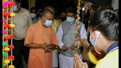 UP chief minister Yogi Adityanath along with union minister Dharmendra Pradhan visits the Mela premises and goods stall during the inauguration ceremony of Diwali mela, at Jhulelal park in Lucknow on Thursday. (ANI Photo)