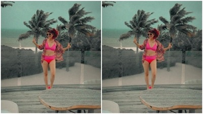 Tahira, in a pink bikini and a printed shrug, posed by the deck. (Instagram/@tahirakashyap) Tahira, in a pink bikini and a printed shrug, posed by the deck. (Instagram/@tahirakashyap)