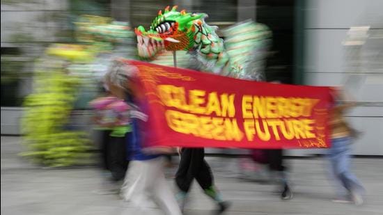 A climate change awareness rally ahead of the COP26 UN summit. India’s goal of achieving 450GW renewable energy by 2030 is likely to be the highlight of its contribution to climate change mitigation at the summit that begins in Glasgow on Sunday. (AP)