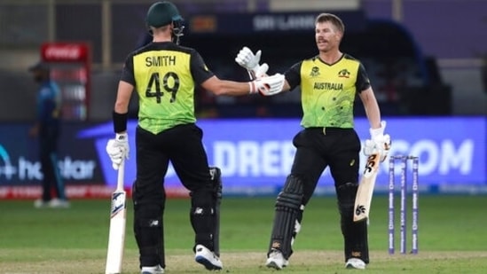 Australia's David Warner, right, celebrates his fifty runs with his teammate Steven Smith during the Cricket Twenty20 World Cup match between Australia and Sri Lanka in Dubai, UAE, Thursday, Oct. 28, 2021. (AP Photo/Aijaz Rahi)(AP)