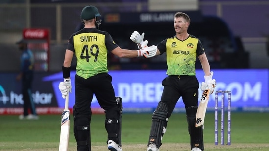 Australia's David Warner, right, celebrates his fifty runs with his teammate Steven Smith during the Cricket Twenty20 World Cup match between Australia and Sri Lanka in Dubai, UAE, Thursday, Oct. 28, 2021. (AP Photo/Aijaz Rahi)(AP)