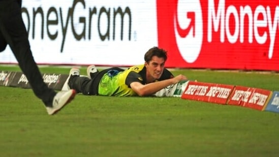 Australia's Pat Cummins dives unsuccessfully to stop a boundary during the Cricket Twenty20 World Cup match between against Sri Lanka in Dubai, UAE, Thursday, Oct. 28, 2021. (AP Photo/Aijaz Rahi)(AP)