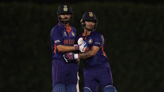 India's captain Virat Kohli, left, congratulates teammate Ishan Kishan on scoring fifty runs(AP)