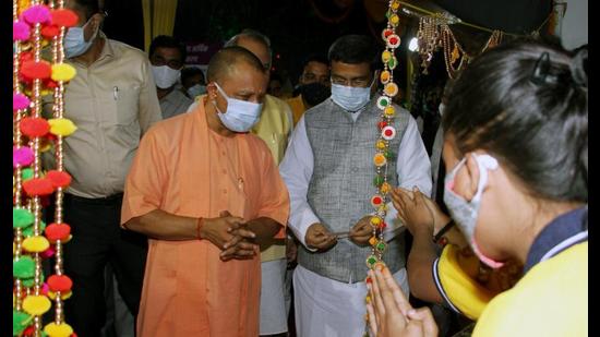 UP chief minister Yogi Adityanath along with union minister Dharmendra Pradhan visits the Mela premises and goods stall during the inauguration ceremony of Diwali mela, at Jhulelal park in Lucknow on Thursday. (ANI Photo)