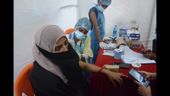 A beneficiary gets vaccinated in Mumbra as part of Thane Municipal Corporation’s drive on Thursday. TMC has started door-to-door survey to understand how many people have been vaccinated. (PRAFUL GANGURDE/HT PHOTO)