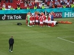 Christian Eriksen receives medical attention after collapsing during the match.