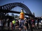 People on social media are sharing Squid Game related content and receiving good response from their fans. In Sydney, a 4.5 metre tall replica doll from the Squid Game has installed at the harbour and fans and rushing to take pictures with the doll.(AFP)