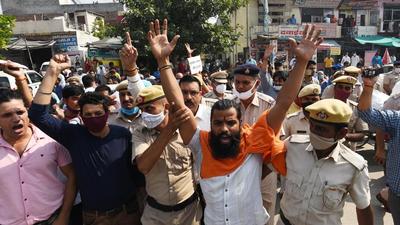 Hindu activists being detained during a protest against namaz offered by Muslim devotees in an open ground, at Sector 12 market, in Gurugram on Friday. (Vipin Kumar /HT PHOTO)