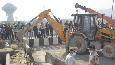 The Delhi Police started removing the concrete boulders, iron spikes and barbed wires from the protest site at Ghazipur border on Friday. (Sakib Ali/HT photo) The Delhi Police started removing the concrete boulders, iron spikes and barbed wires from the protest site at Ghazipur border on Friday. (Sakib Ali/HT photo)