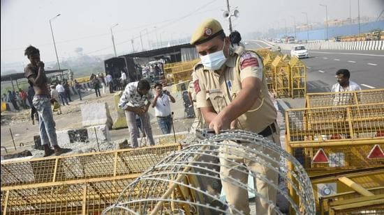 Police remove barricades at the Ghazipur farmers’ protest site on the border with New Delhi on Friday. (Sakib Ali/ HT photo)