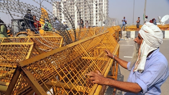 A farmer looking at the removal of barricades from the Ghazipur border where farmers are protesting against the three farm laws, in New Delhi on Friday.(ANI)