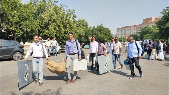 The election staff carrying EVMs and other material to a polling station at Ellenabad in Haryana’s Sirsa district on Friday. (HT Photo)