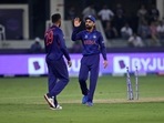 Indian cricket captain Virat Kohli, right, speaks with teammate India's Varun Chakravarthy(AP) Indian cricket captain Virat Kohli, right, speaks with teammate India's Varun Chakravarthy(AP)