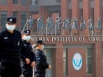 Security personnel keep watch outside the Wuhan Institute of Virology during the visit by the World Health Organisation (WHO) team tasked with investigating the origins of the coronavirus disease (Covid-19).&nbsp;