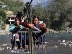 Voters cross a river to cast their vote in the Mandi Lok Sabha bypoll, in Kullu district on Saturday. (Aqil Khan/Hindustan Times) Voters cross a river to cast their vote in the Mandi Lok Sabha bypoll, in Kullu district on Saturday. (Aqil Khan/Hindustan Times)