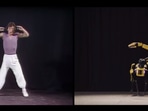The image shows the robot imitating Mick Jagger's moves.