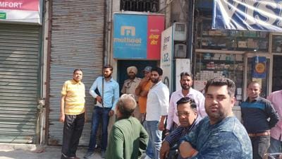 After the robbery bid, people gather outside the Muthoot Finance Gold Loan branch at Sundar Nagar in Ludhiana on Saturday. (HT Photo)
