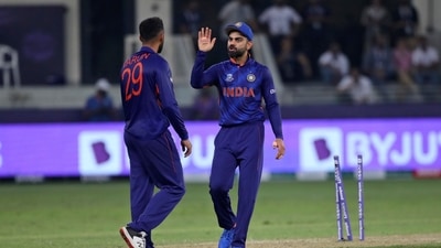 Indian cricket captain Virat Kohli, right, speaks with teammate India's Varun Chakravarthy (AP)