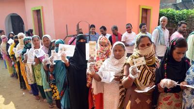 Voters show their identity cards before casting their respective votes at a polling station, during Tarapur assembly by-polls, in Munger district, Saturday. (PTI) Voters show their identity cards before casting their respective votes at a polling station, during Tarapur assembly by-polls, in Munger district, Saturday. (PTI)