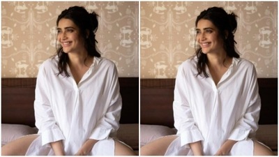 She perched up on a bed and posed for the pictures in an indoor setup. (Instagram/@karishmaktanna) She perched up on a bed and posed for the pictures in an indoor setup. (Instagram/@karishmaktanna)