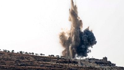 A plume of heavy smoke rises above a hill, during an airstrike by pro-regime forces in the rebel-held northern countryside of Syria's Idlib province. (AFP)
