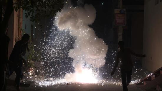 Gurugram, India-November 14: People bursting firecrackers in the streets during Diwali at Sector-11 near Khandsa Road, in Gurugram, India, on Saturday, November 14, 2020. (Photo by Parveen Kumar/Hindustan Times)