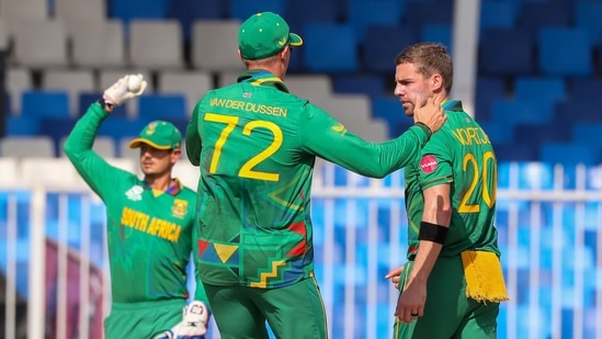 South Africa's Anrich Nortje, right, is congratulated by teammate Rassie van der Dussen after dismissing Sri Lanka's Kusal Perera during the Cricket Twenty20 World Cup match between South Africa and Sri Lanka in Sharjah, UAE, Saturday, Oct. 30, 2021. (AP Photo/Kamran Jebreili)(AP)